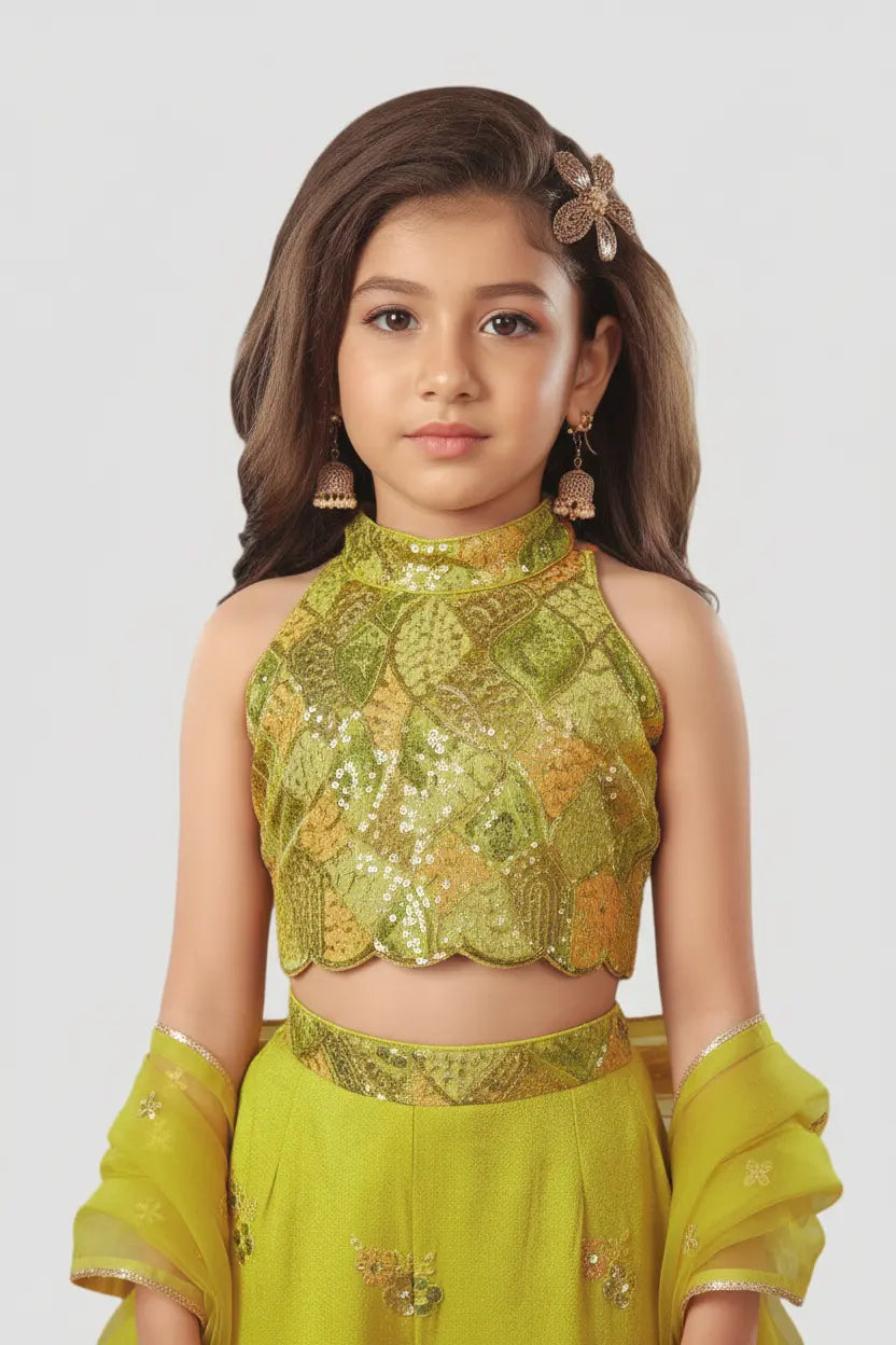 Young girl wearing a green traditional outfit with floral patterns on a white background