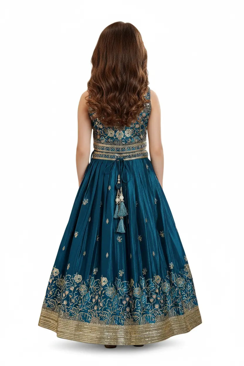 Woman wearing a blue embroidered dress with floral patterns on a white background