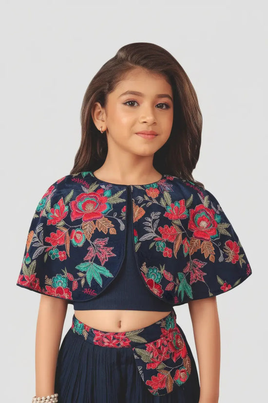 Young girl wearing a floral embroidered outfit on a white background
