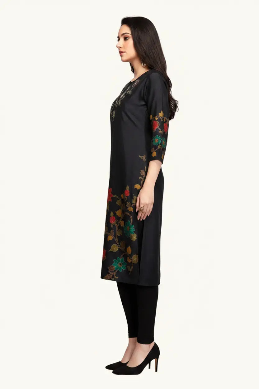 Woman wearing a black kurta with floral patterns on sleeves against a white background