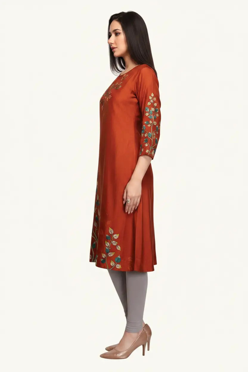 Woman wearing a rust-colored kurta with floral embroidery on a white background