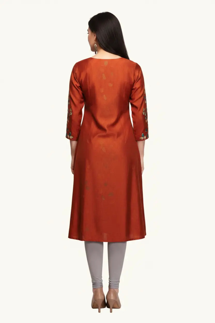 Woman wearing a rust-colored kurta with intricate patterns on a white background