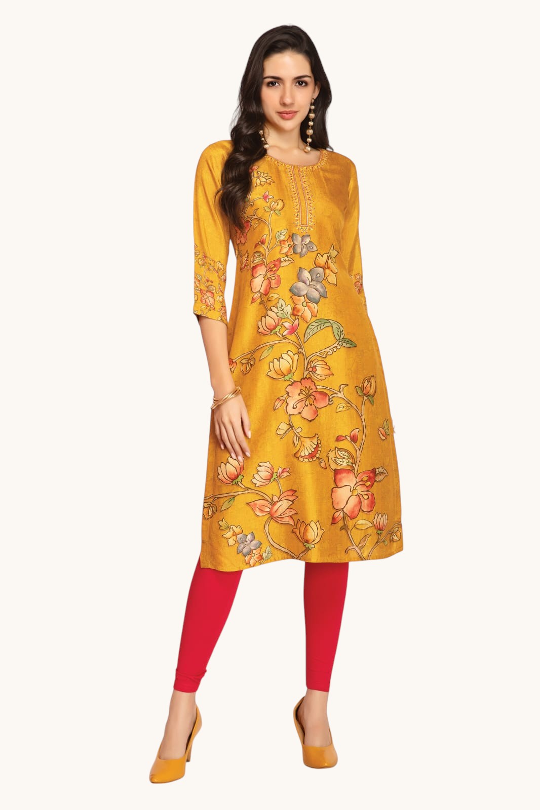 Woman wearing a yellow floral dress with red leggings on a white background