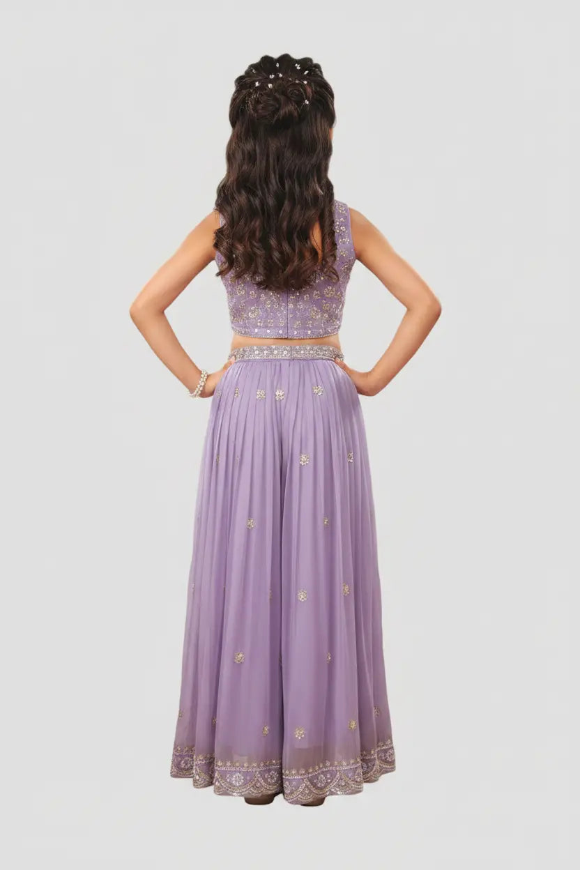 Woman wearing a purple embroidered outfit on a light gray background
