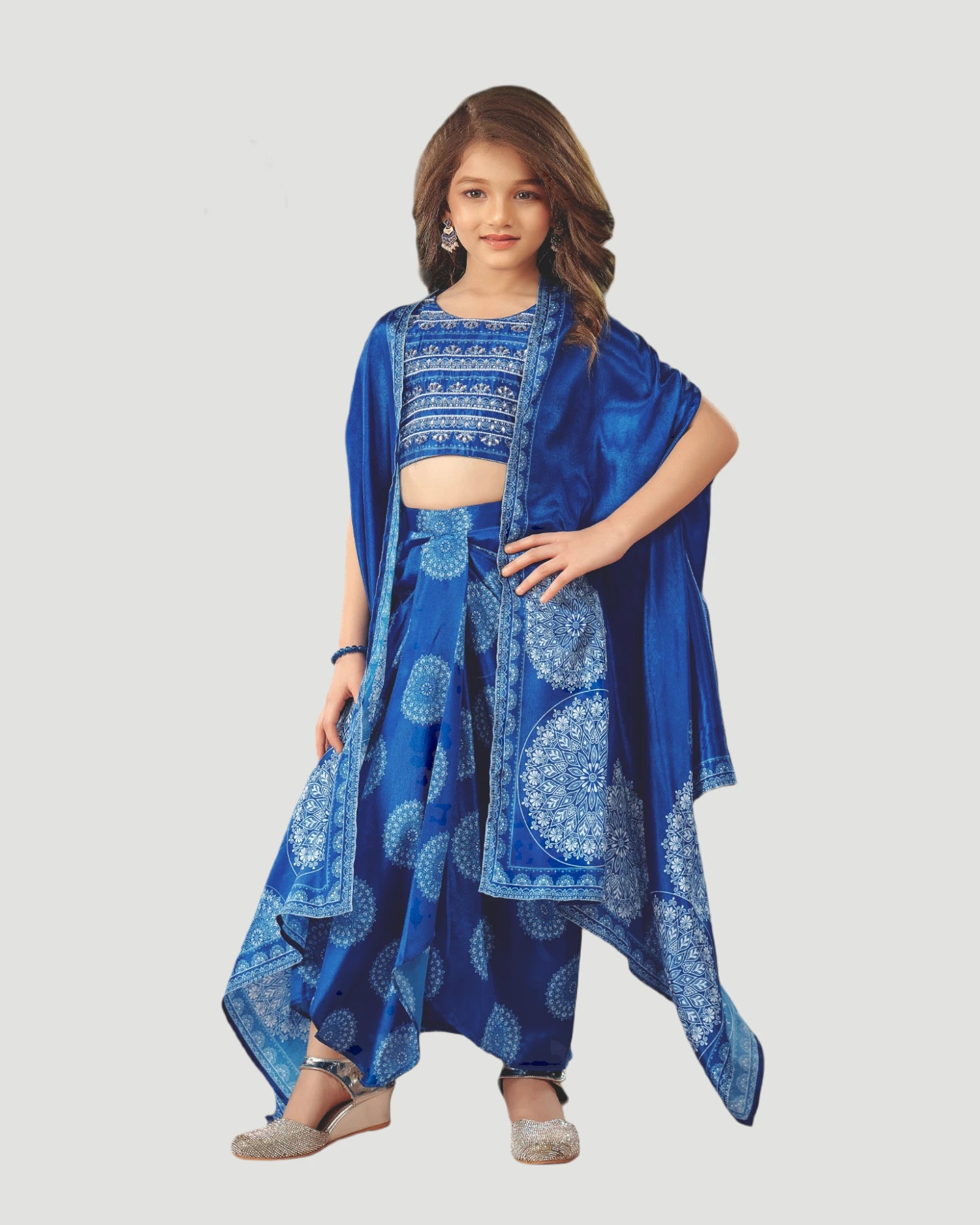 Young girl wearing a blue traditional outfit with a patterned dupatta on a white background