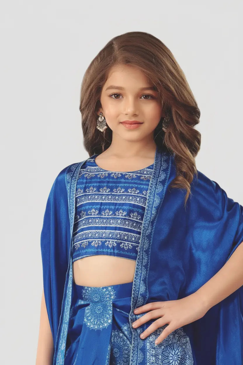 Young girl wearing a blue traditional outfit with intricate patterns on a white background