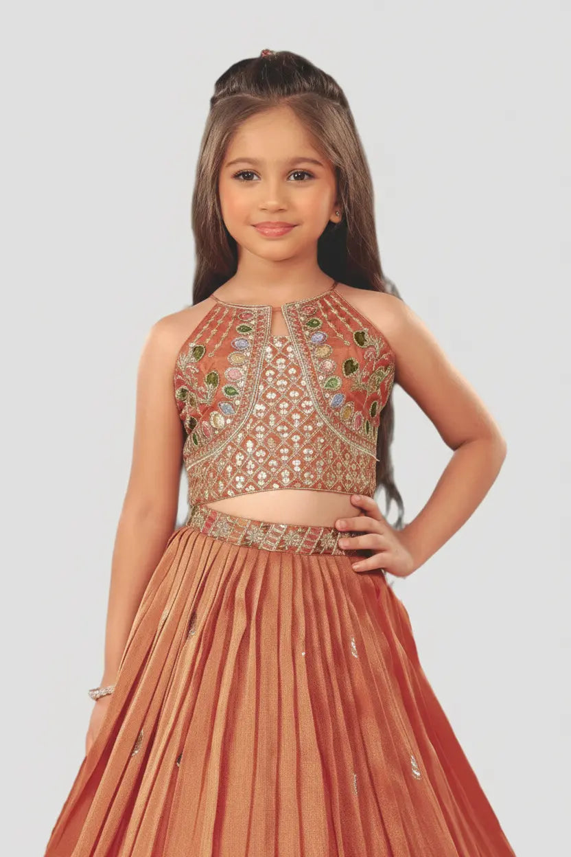 Young girl wearing a traditional outfit with intricate designs on a plain background
