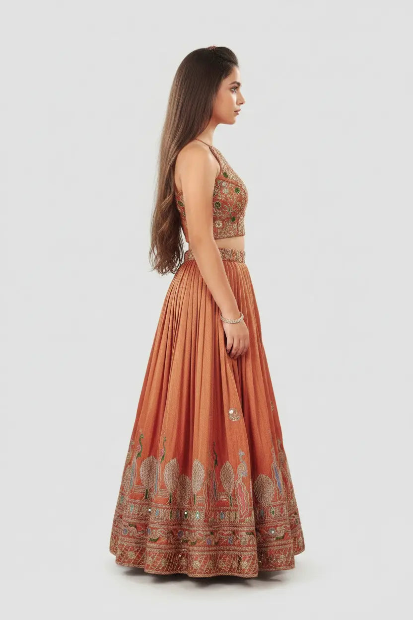 Woman wearing a traditional orange and gold outfit with intricate patterns on a white background