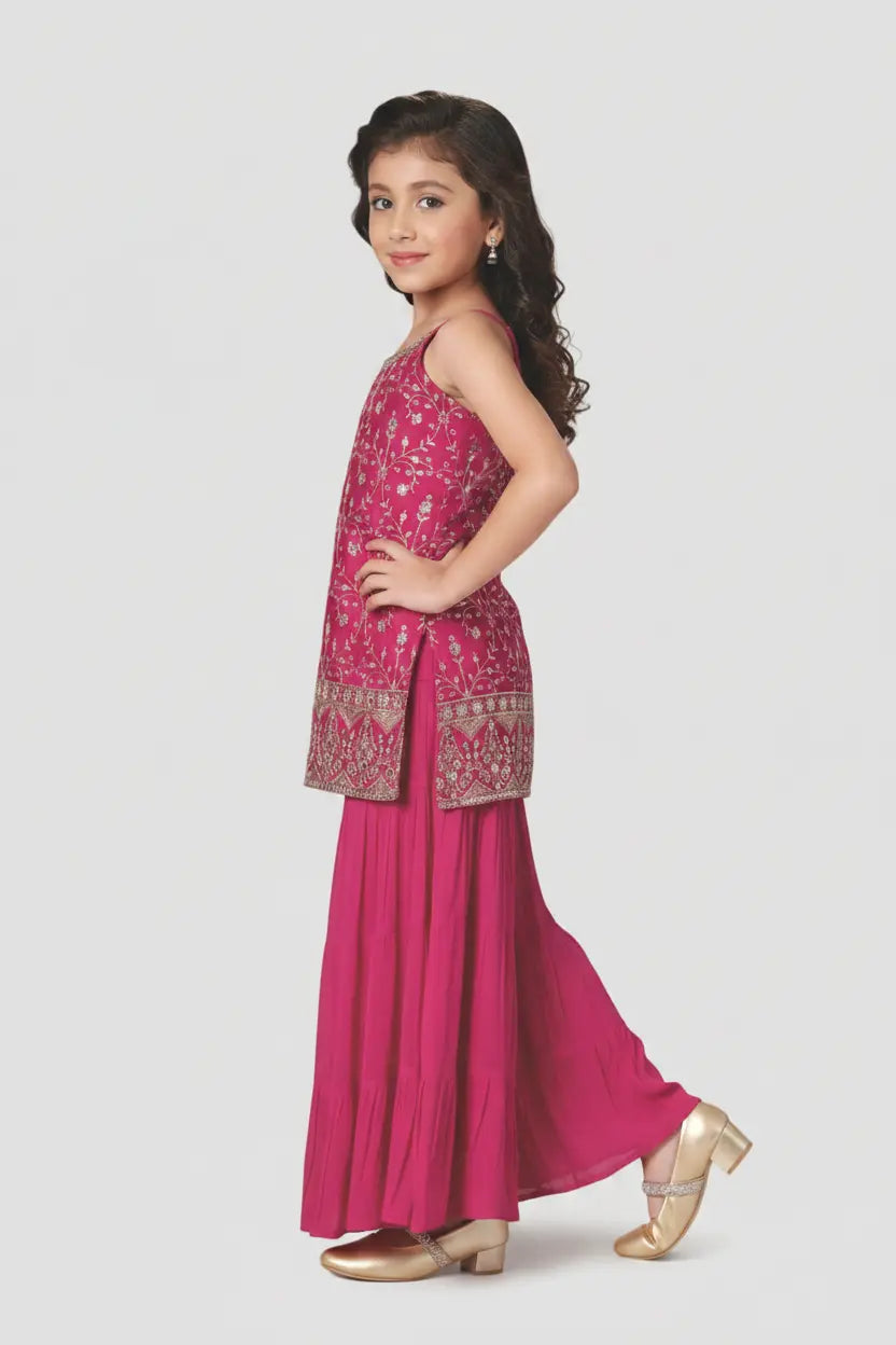 Young girl wearing a pink traditional outfit with a white background