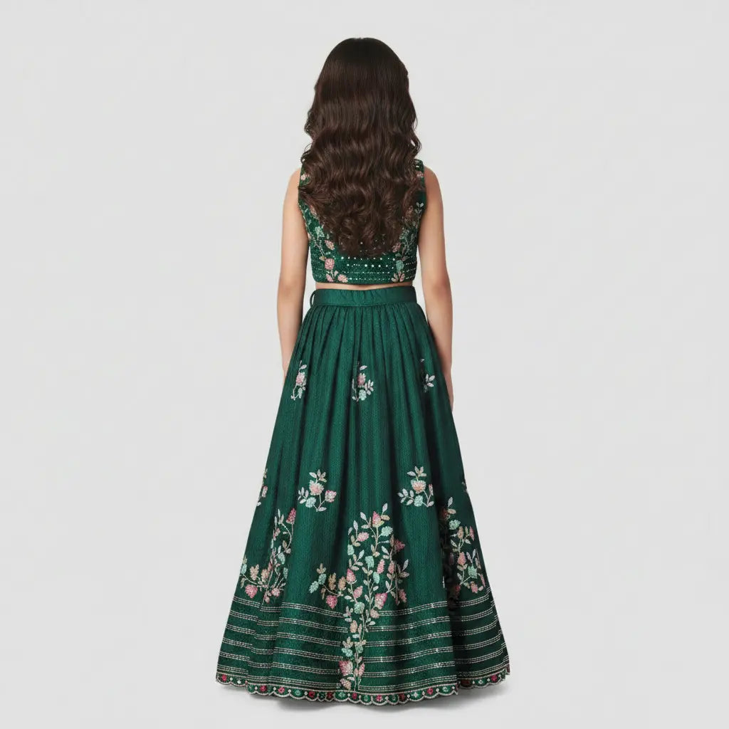 Green embroidered traditional outfit on a plain background