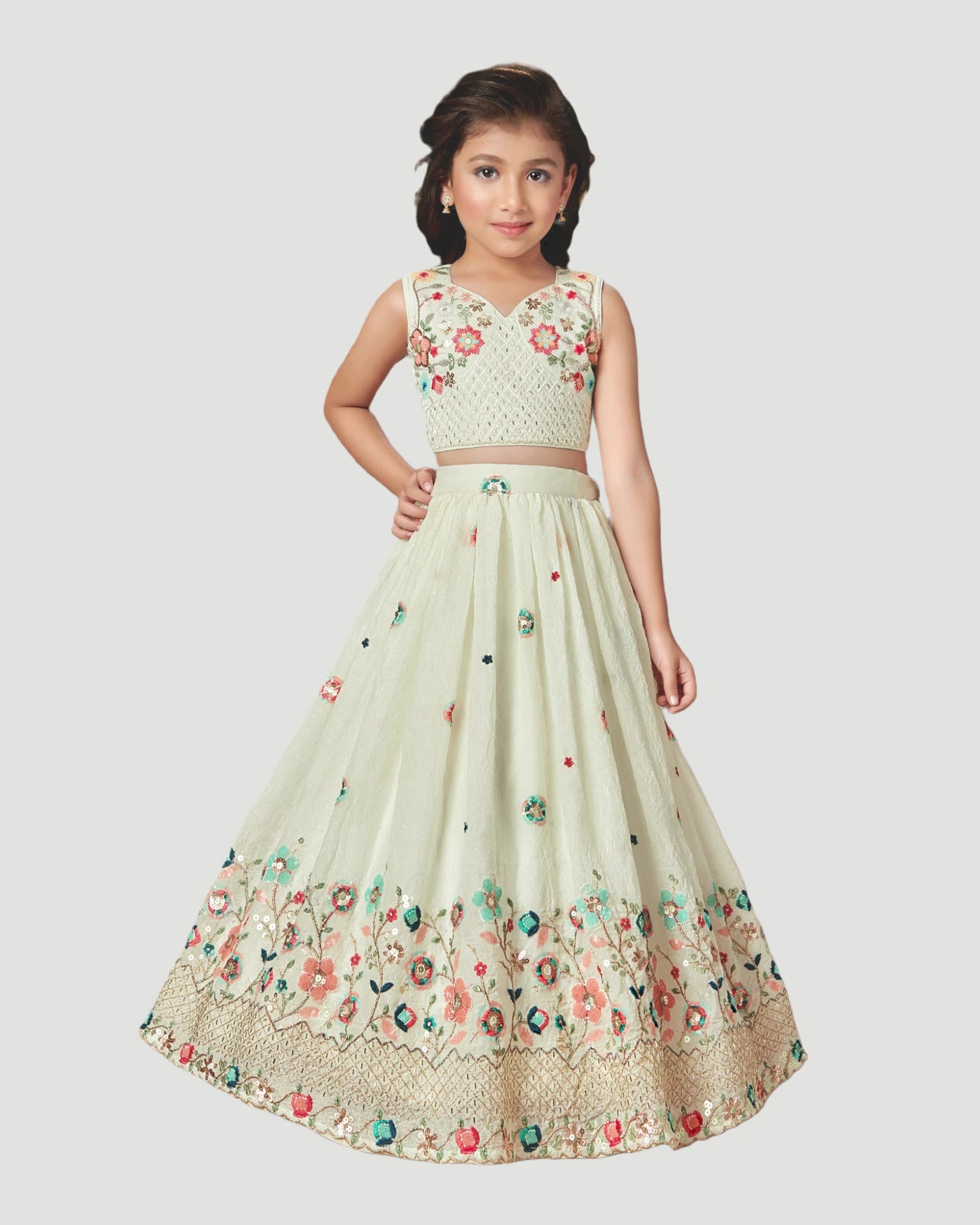 Young girl wearing a floral embroidered outfit on a white background