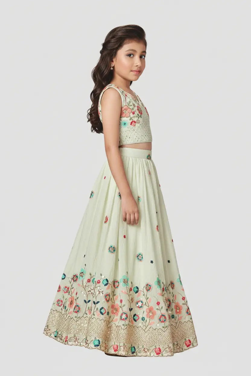 Young girl wearing a floral embroidered outfit on a white background