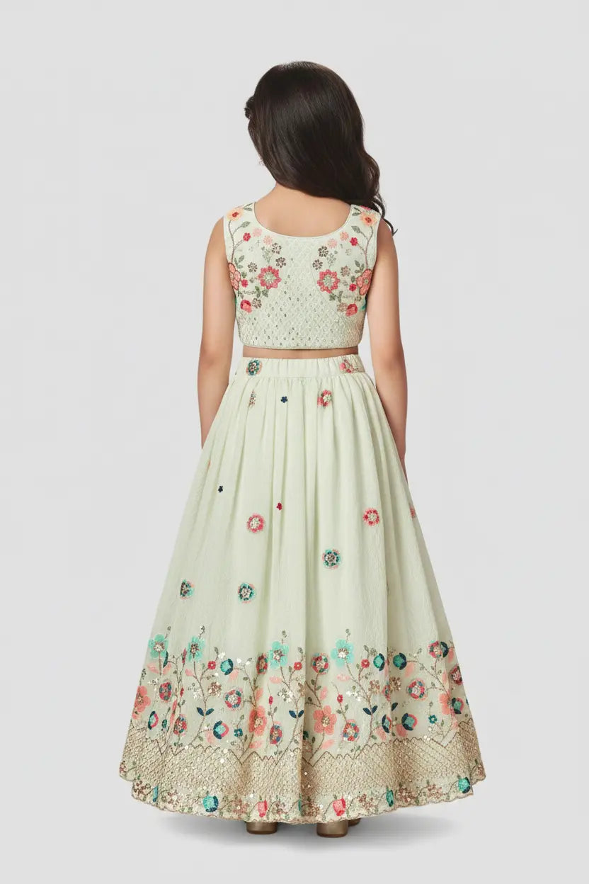 Woman wearing a floral embroidered dress on a white background