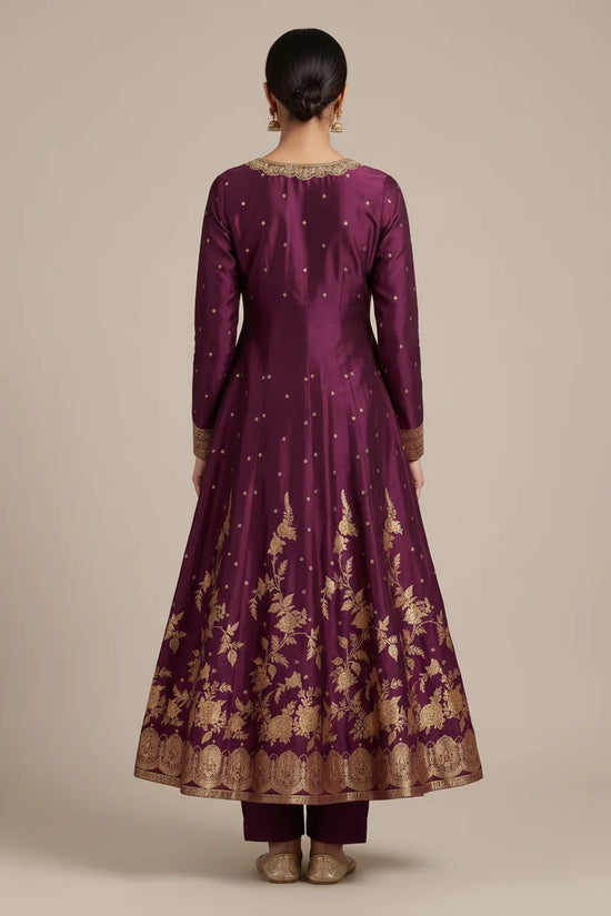 Purple traditional outfit with gold embroidery on a beige background