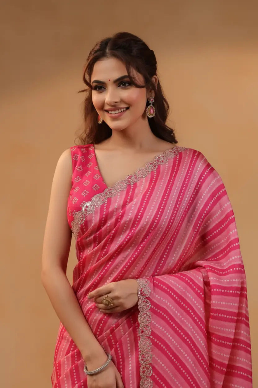 Woman wearing a pink saree with a beige background