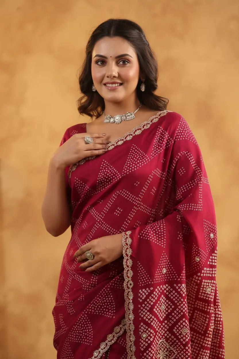 Woman wearing a red saree with white patterns against a beige background