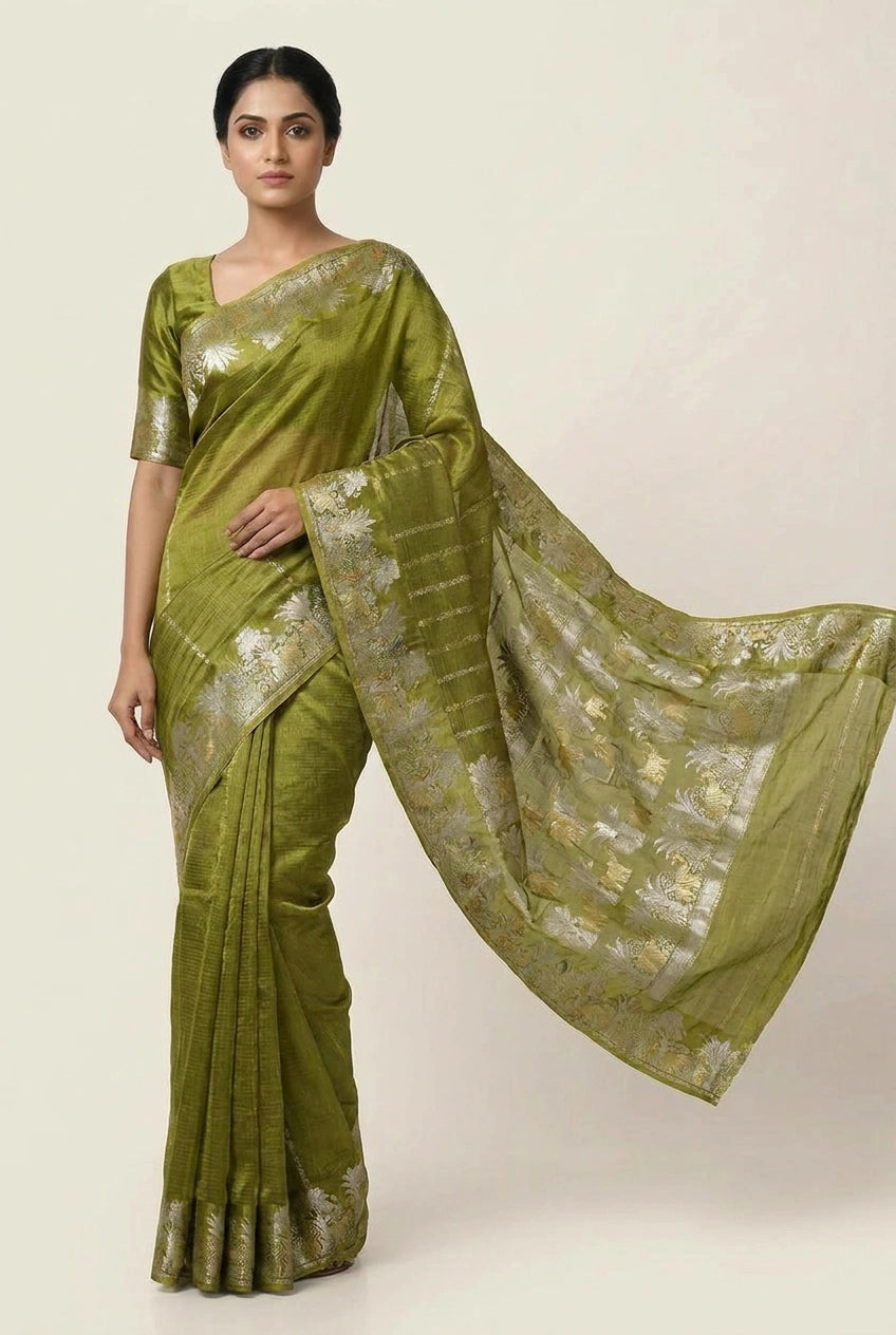 Woman wearing a green saree with a white background