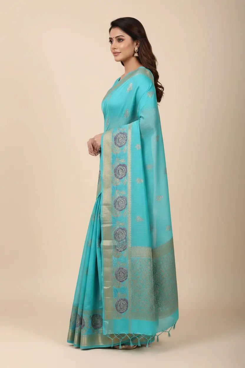 Woman wearing a turquoise saree with a beige background
