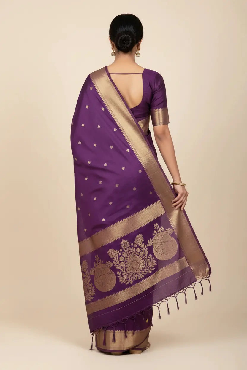 Purple saree with gold border and patterns on a beige background