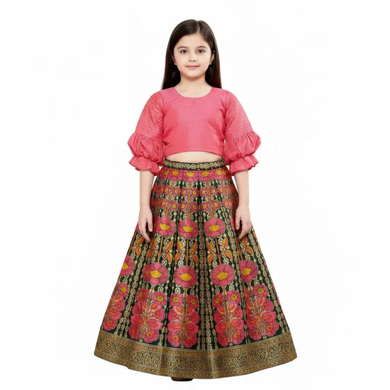 Young girl wearing a pink top and floral skirt on a white background