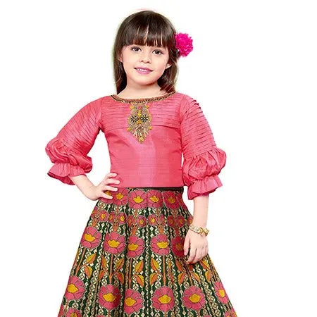 Young girl wearing a pink traditional outfit with a floral skirt on a white background