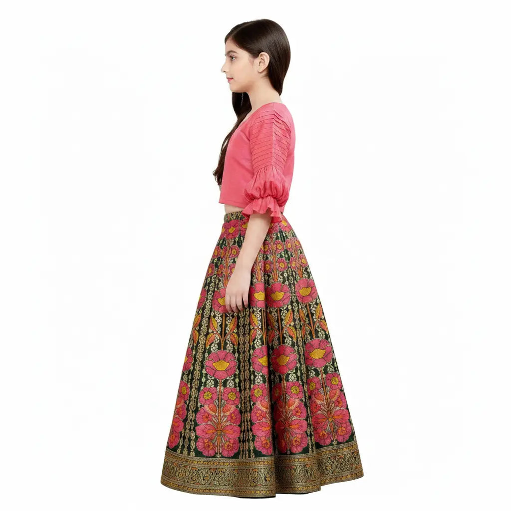 Woman wearing a pink blouse and patterned skirt on a white background
