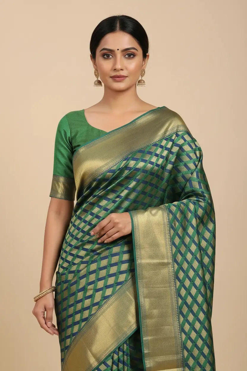 Woman wearing a green and gold saree with a beige background