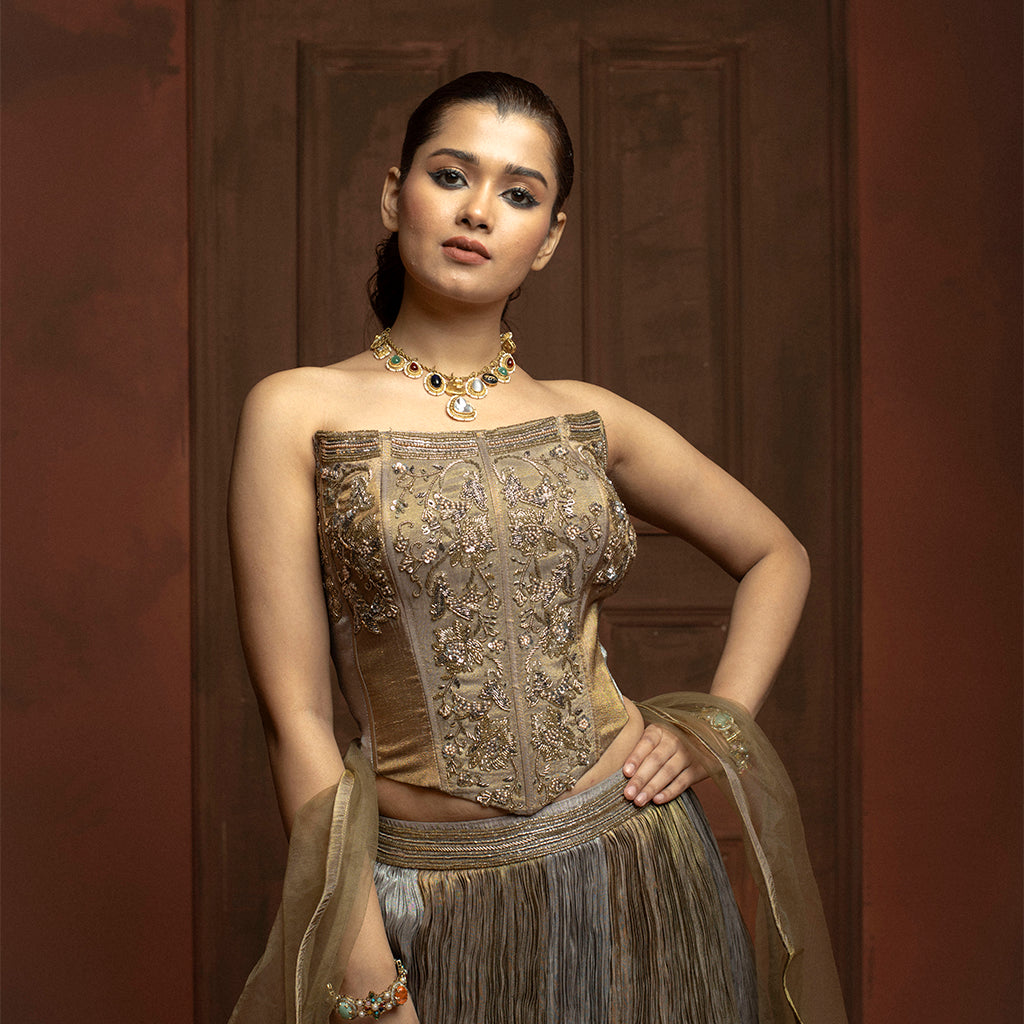 Woman wearing an ornate traditional outfit with a brown background