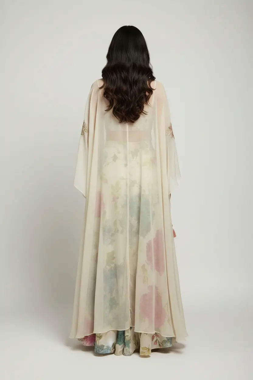 Woman wearing a sheer, floral-patterned dress with a white background