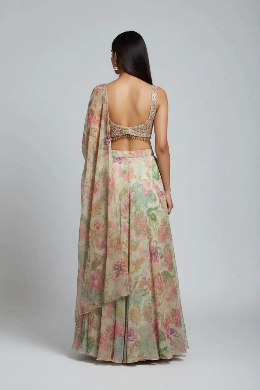 Woman wearing a floral saree with a plain background
