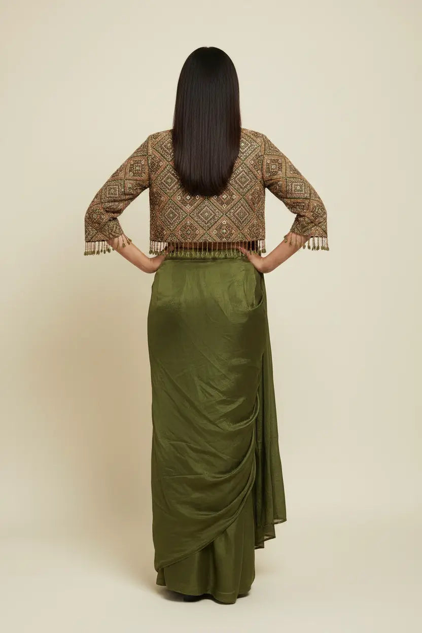 Woman wearing a patterned top and green skirt on a beige background
