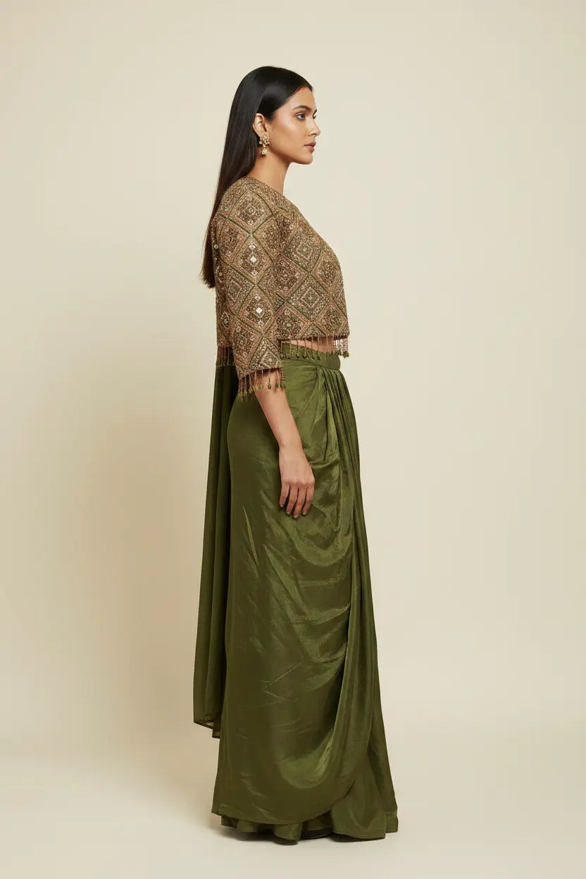 Woman wearing a patterned top and green skirt on a beige background