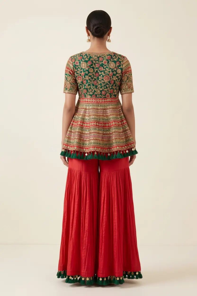 Woman wearing a traditional outfit with a patterned top and red pants on a beige background
