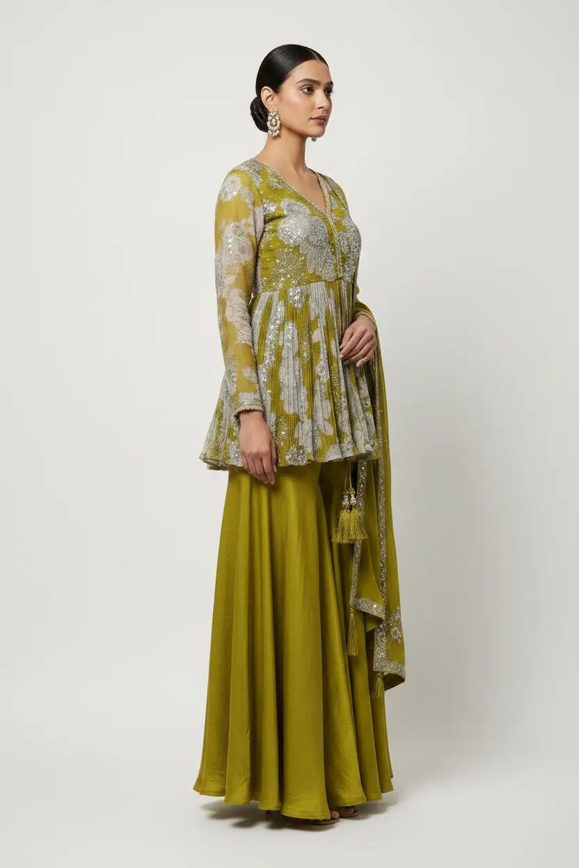 Woman wearing a green and white traditional outfit with a plain background