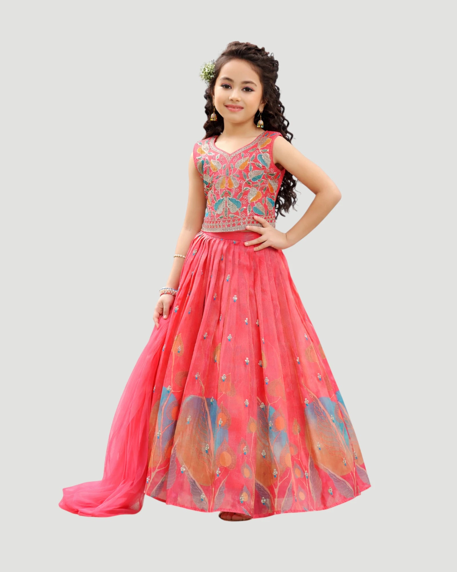 Young girl wearing a pink and multicolored dress on a light gray background