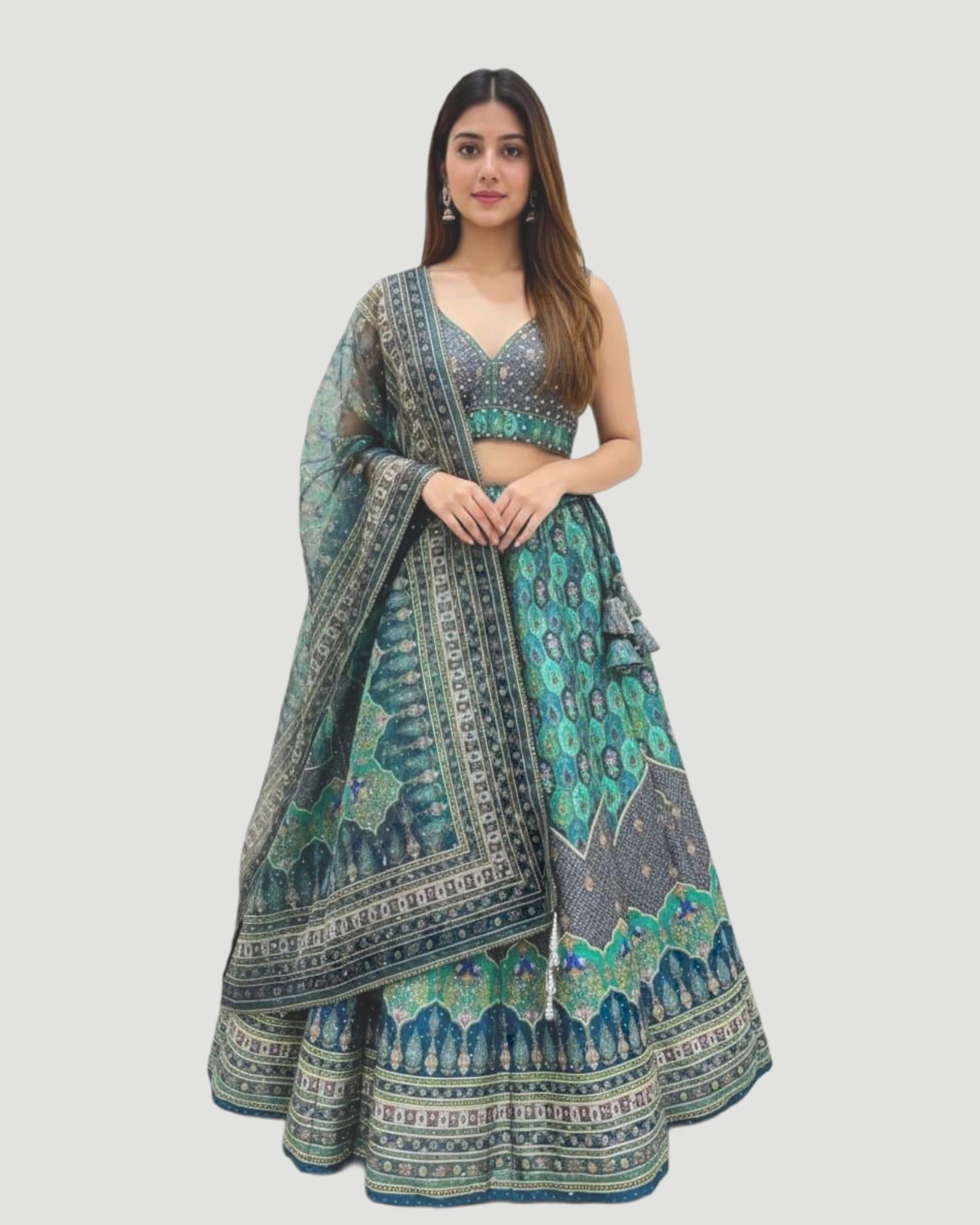 Woman wearing a traditional green and blue patterned outfit on a white background
