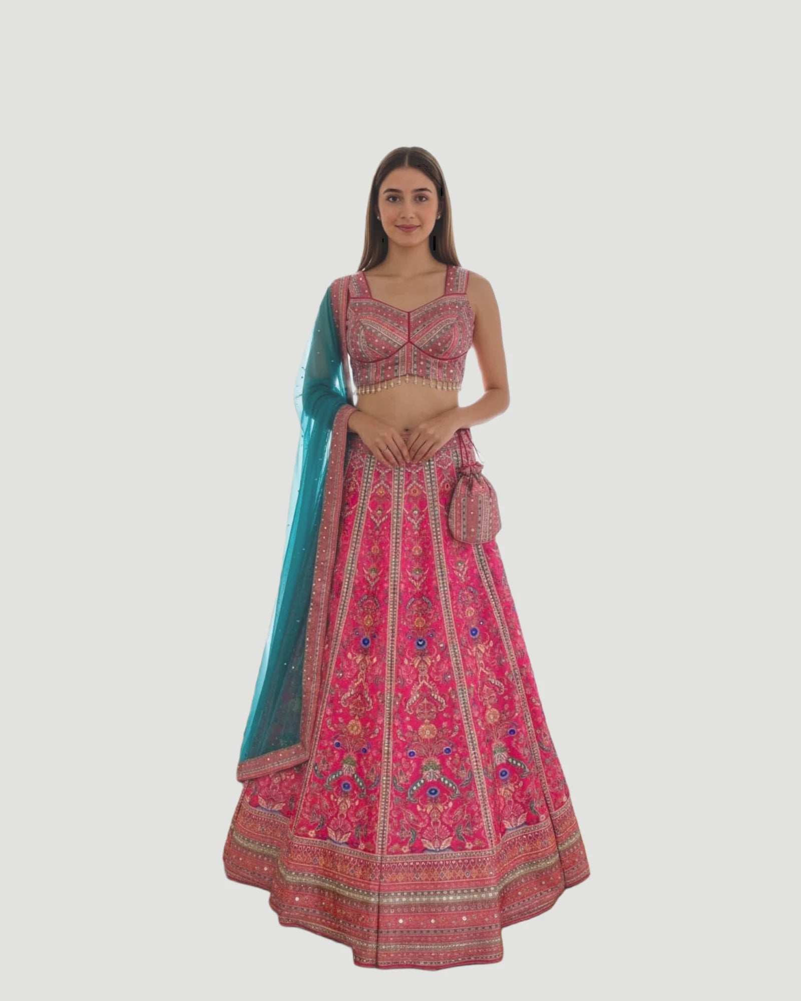 Woman wearing a pink embroidered traditional outfit with a blue dupatta on a white background