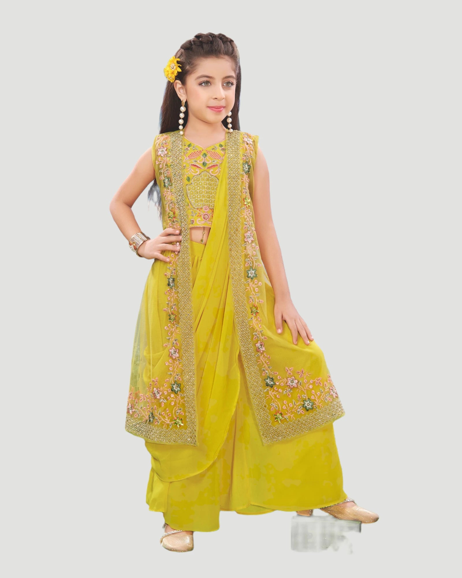 Young girl wearing a yellow traditional outfit with intricate designs