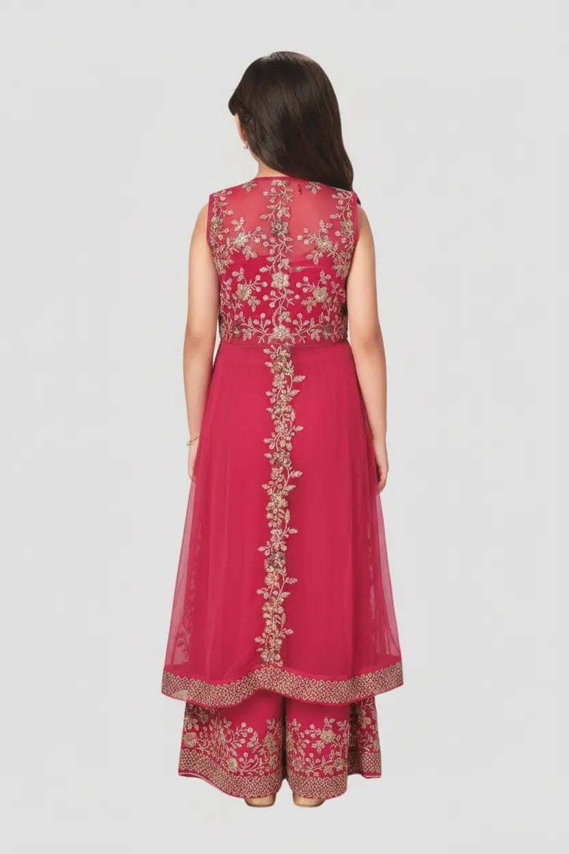 Woman wearing a pink embroidered traditional outfit on a white background