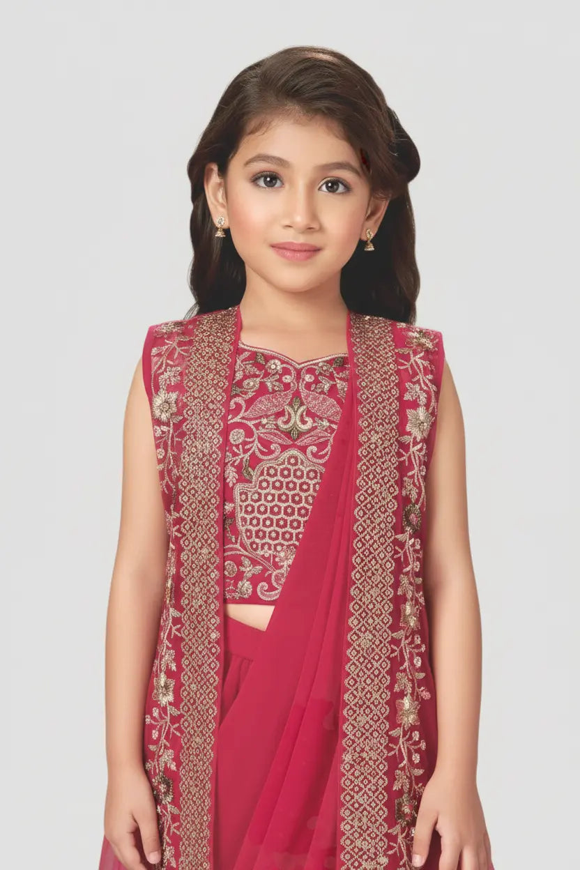 Young girl wearing a pink traditional outfit with intricate patterns on a white background
