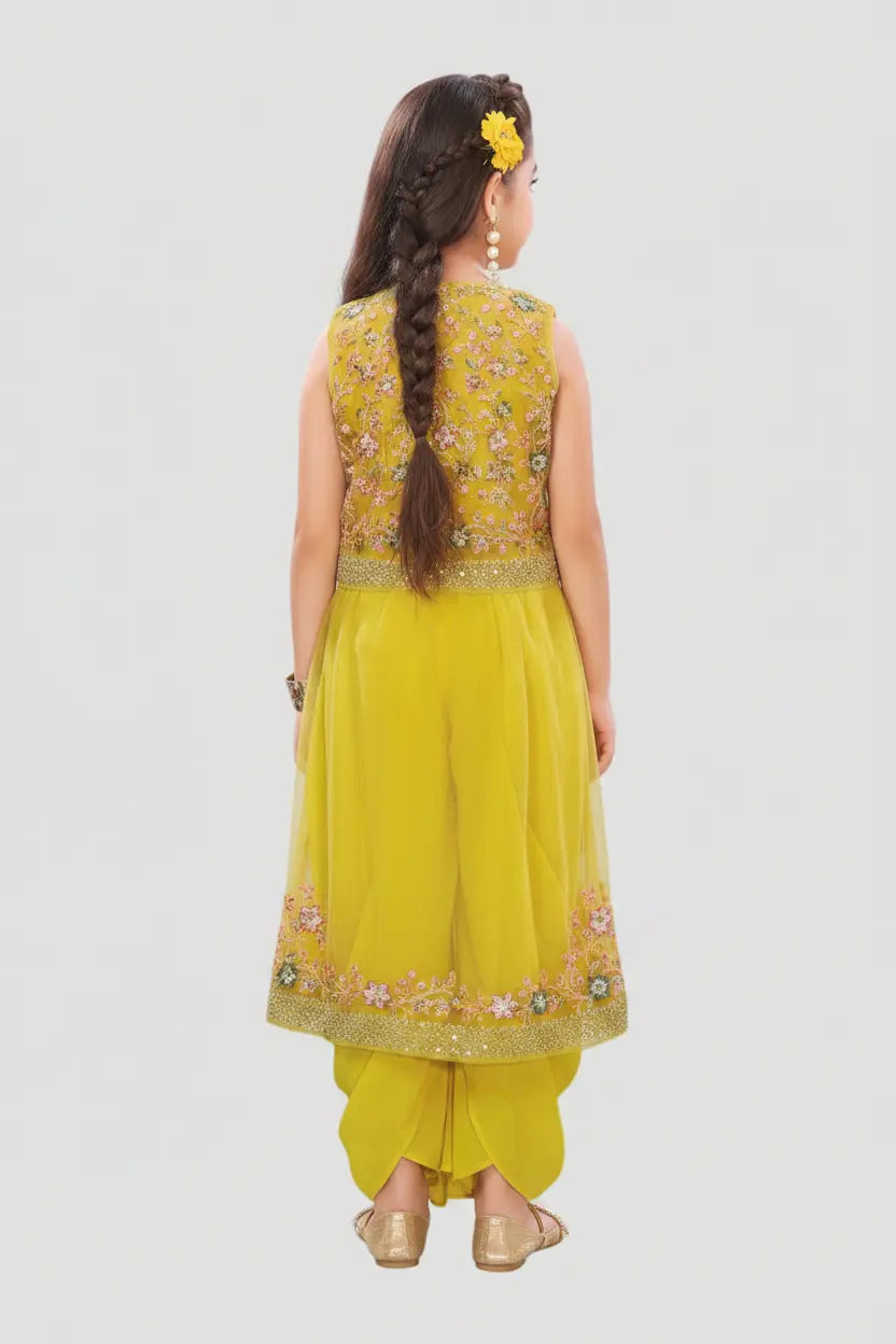 Young girl wearing a yellow traditional outfit with intricate designs on a white background