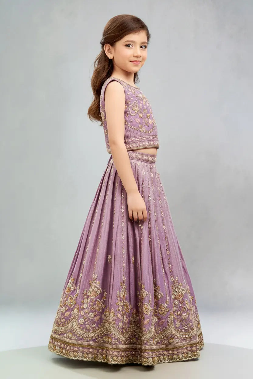 Young girl wearing a purple embroidered traditional outfit on a plain background