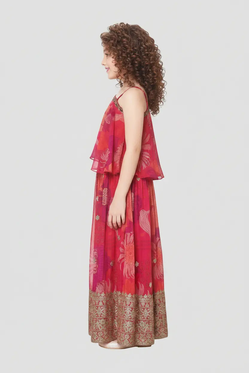 Woman wearing a red and pink patterned dress on a light gray background