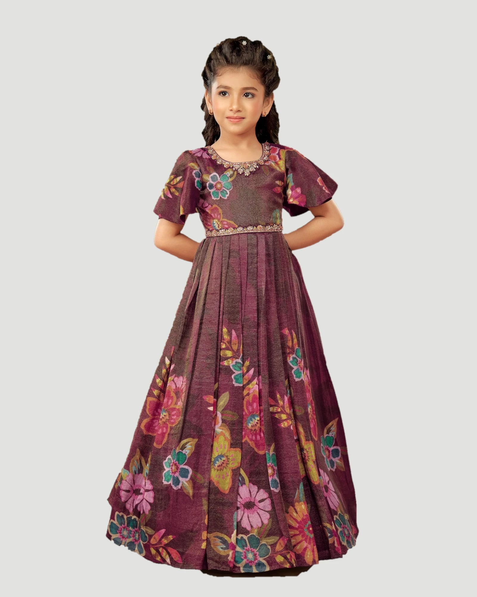 Young girl wearing a floral dress on a light gray background