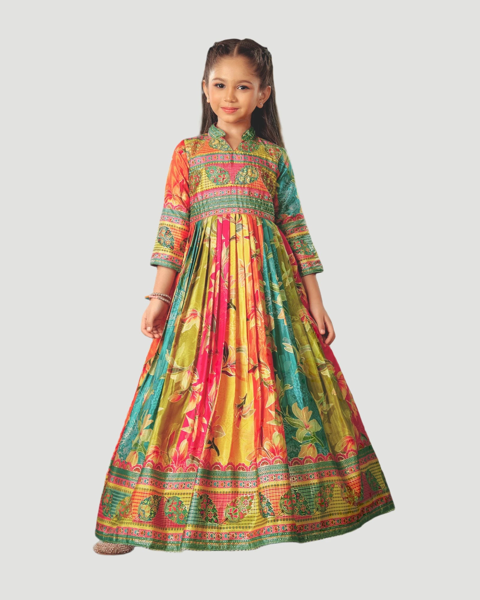 Young girl wearing a colorful traditional dress on a white background