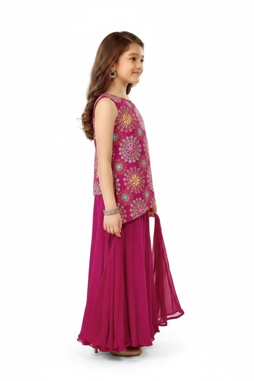 Young girl wearing a pink traditional outfit with floral patterns on a white background