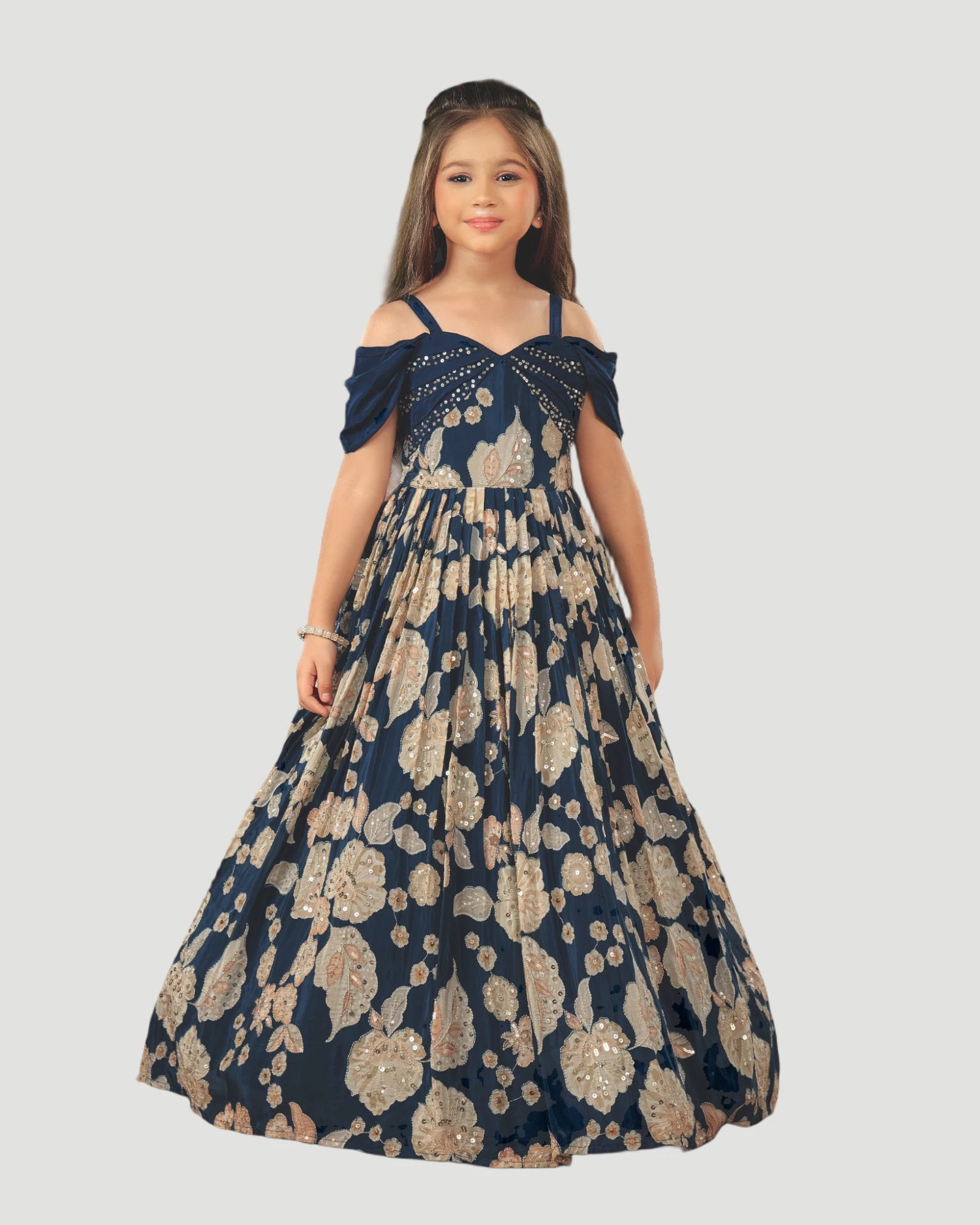 Girl wearing a navy blue and beige patterned dress on a white background