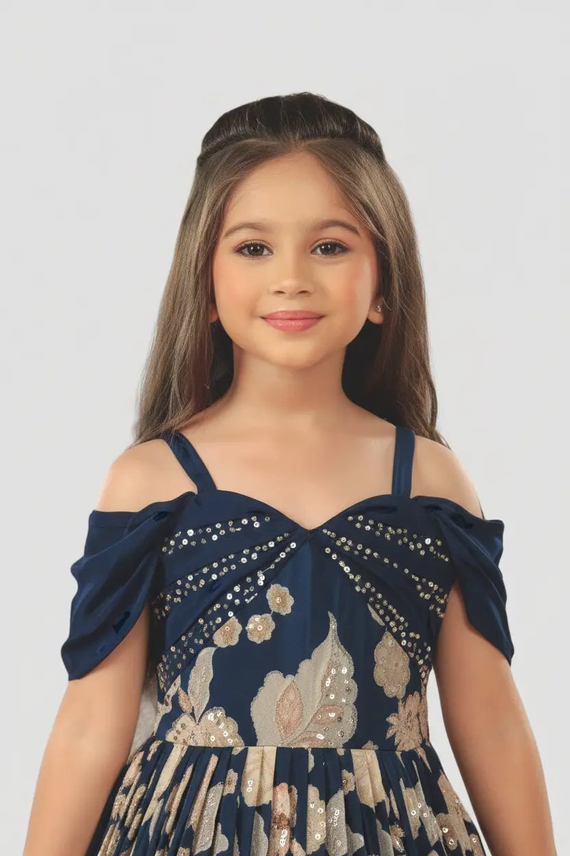 Young girl wearing a navy blue dress with floral patterns on a white background