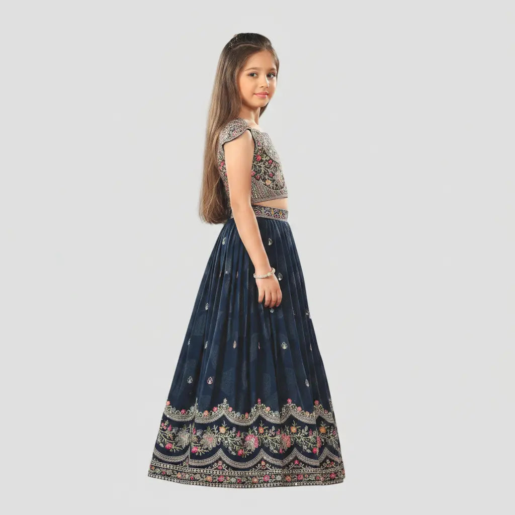 Young girl wearing a traditional outfit with a dark blue skirt and embroidered top on a light gray background
