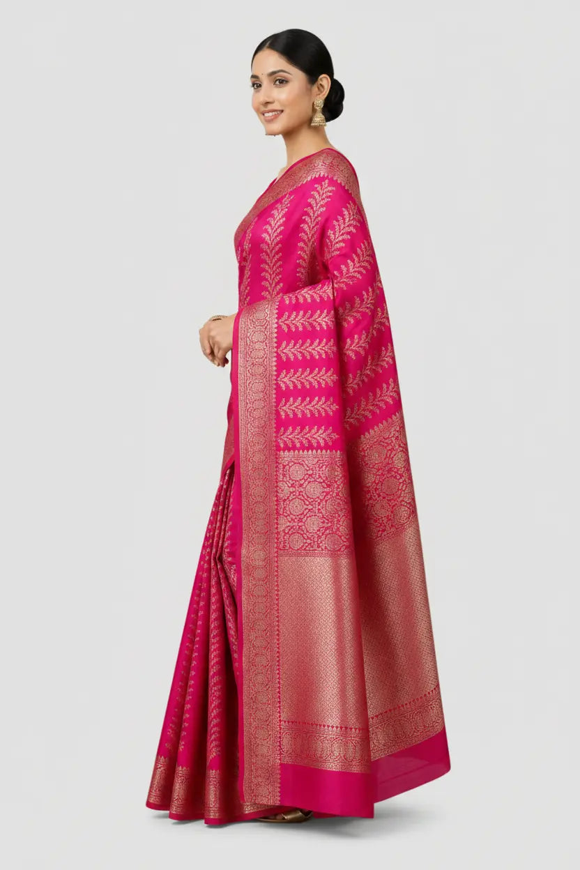 Woman wearing a pink saree with a white border on a light gray background